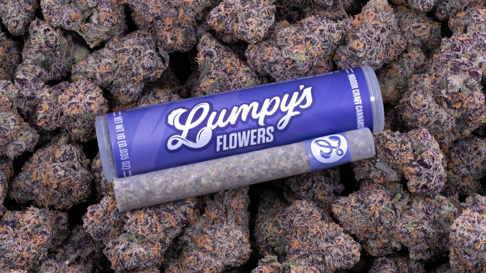 1g pre-roll with a glass tip on a bed of purple flower